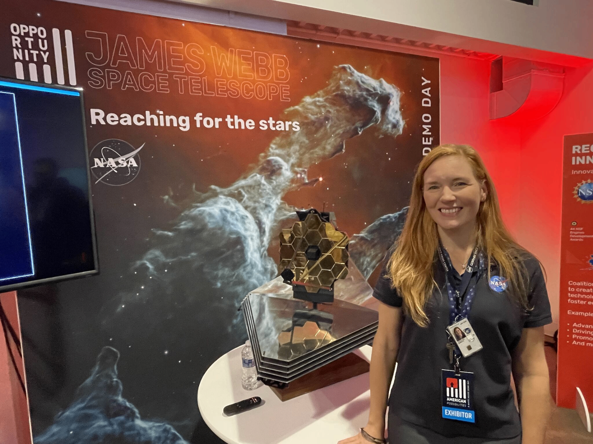 NASA exhibitor with James Webb Space Telescope model and 'Reaching for the stars' backdrop